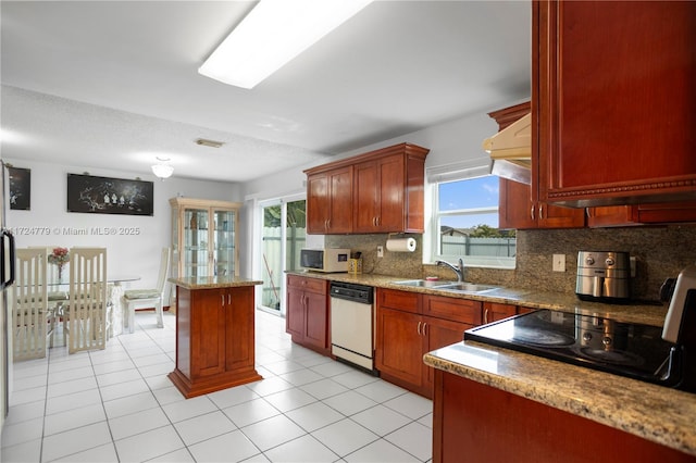 kitchen featuring white appliances, plenty of natural light, backsplash, and a sink