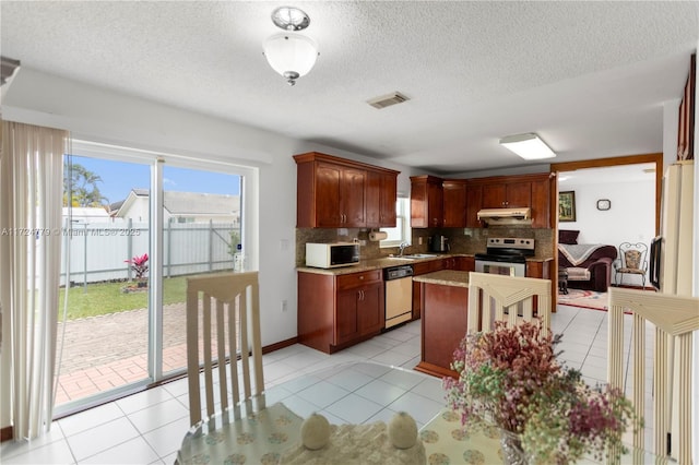 kitchen with white microwave, under cabinet range hood, a sink, electric stove, and dishwasher