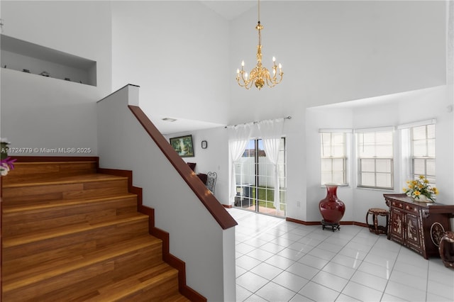 stairs featuring tile patterned flooring, a high ceiling, baseboards, and an inviting chandelier