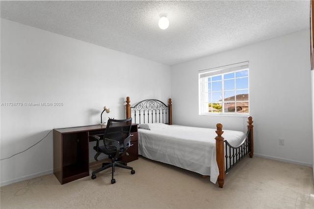 carpeted bedroom featuring a textured ceiling and baseboards