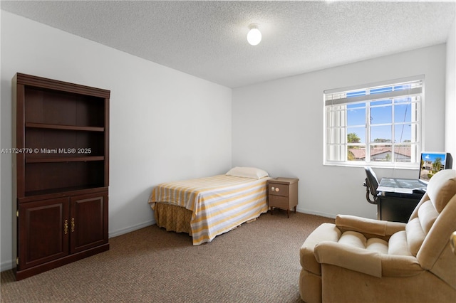 bedroom featuring carpet, baseboards, and a textured ceiling