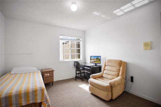 carpeted bedroom featuring a textured ceiling and baseboards