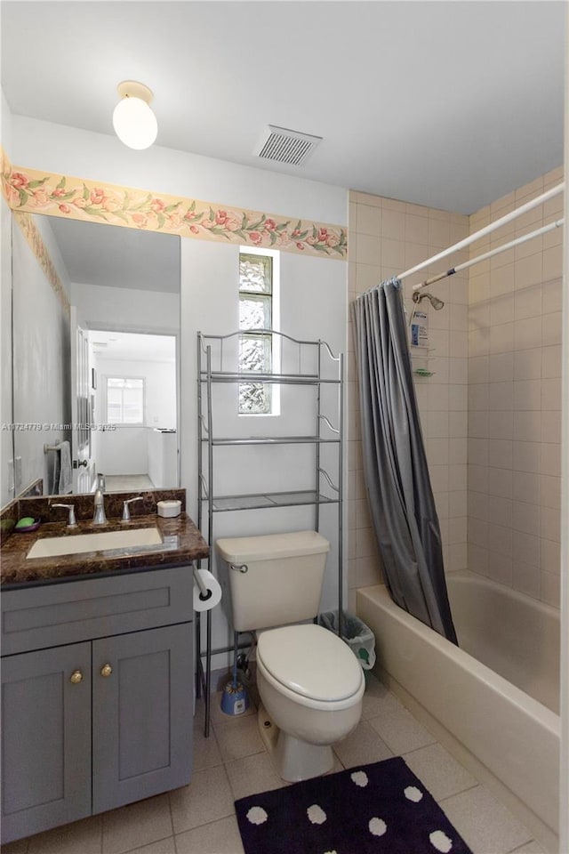 bathroom featuring shower / bath combination with curtain, tile patterned flooring, visible vents, and toilet