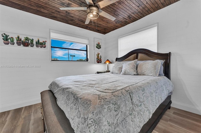 bedroom with hardwood / wood-style floors, ceiling fan, and wood ceiling