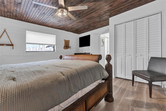 bedroom with ceiling fan, a closet, wood ceiling, and light hardwood / wood-style flooring