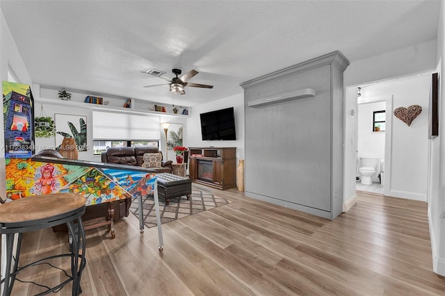 rec room with hardwood / wood-style flooring, ceiling fan, and a healthy amount of sunlight