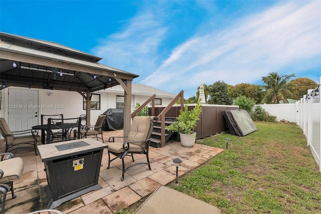 view of patio featuring a gazebo, an outdoor fire pit, and a grill