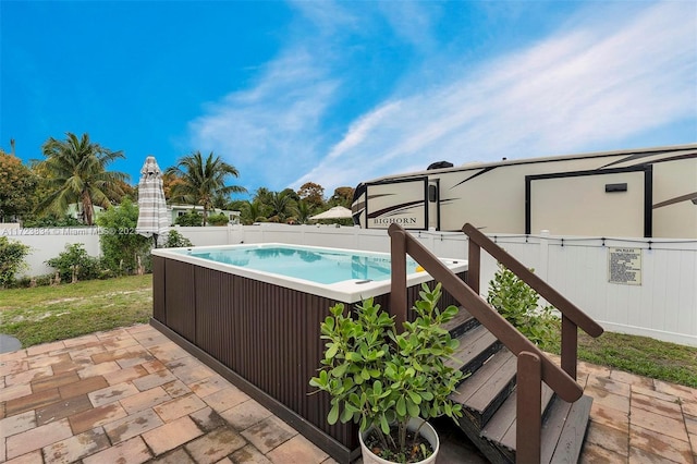 view of swimming pool featuring a hot tub