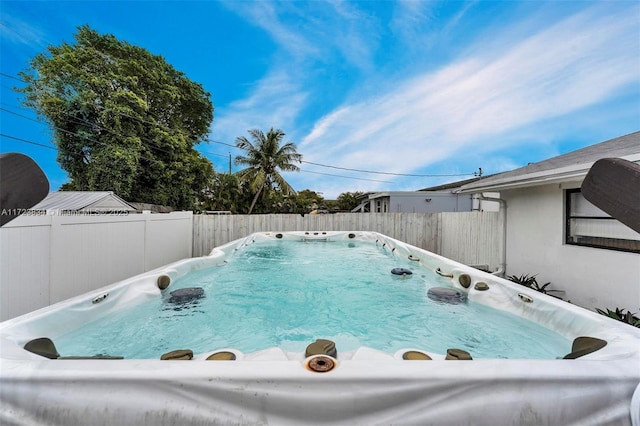 view of pool with a hot tub