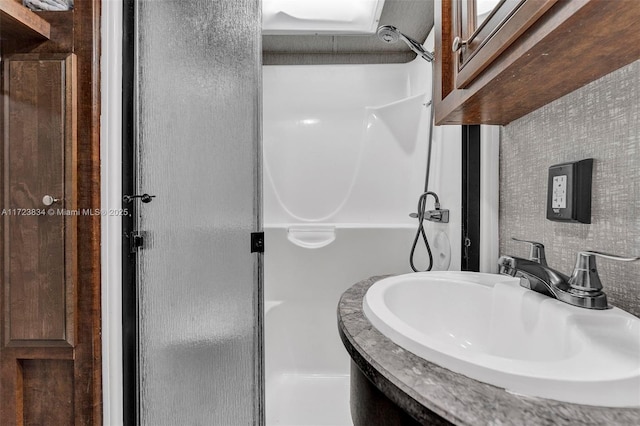 bathroom featuring a shower and sink