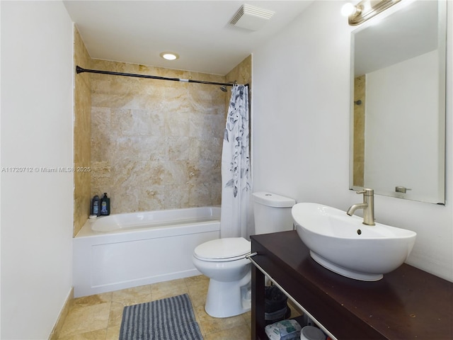 full bathroom with sink, shower / bath combo with shower curtain, and toilet