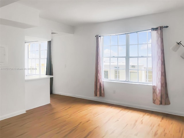 unfurnished room with hardwood / wood-style flooring