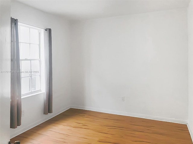 spare room featuring light wood-type flooring