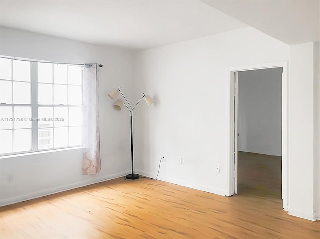 empty room with light hardwood / wood-style flooring