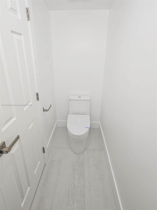 bathroom featuring tile patterned flooring and toilet