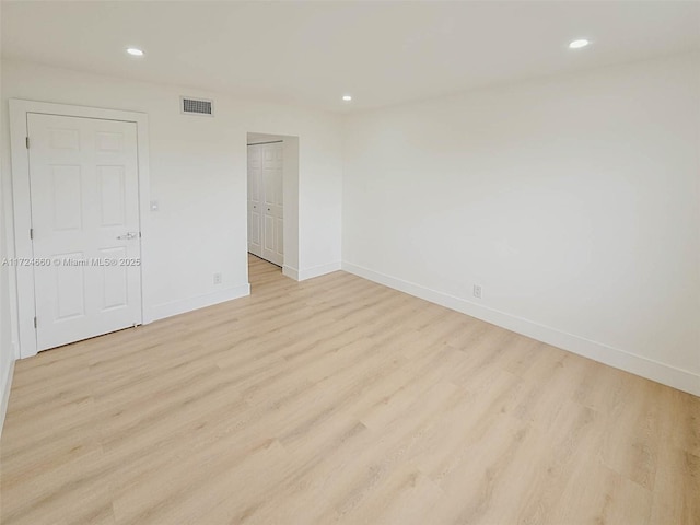 unfurnished room with light hardwood / wood-style flooring