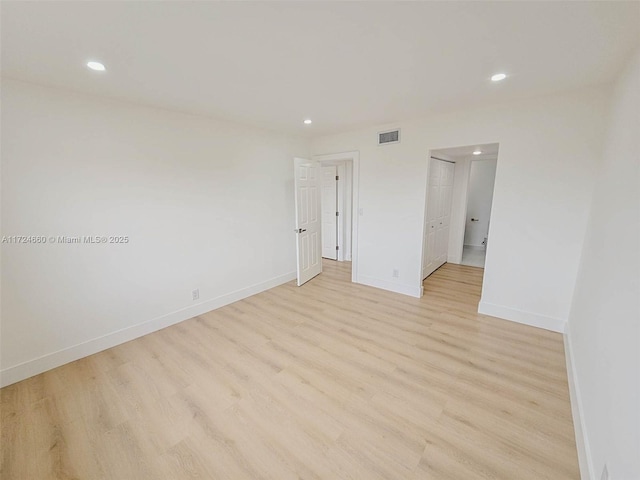 unfurnished room with light hardwood / wood-style flooring