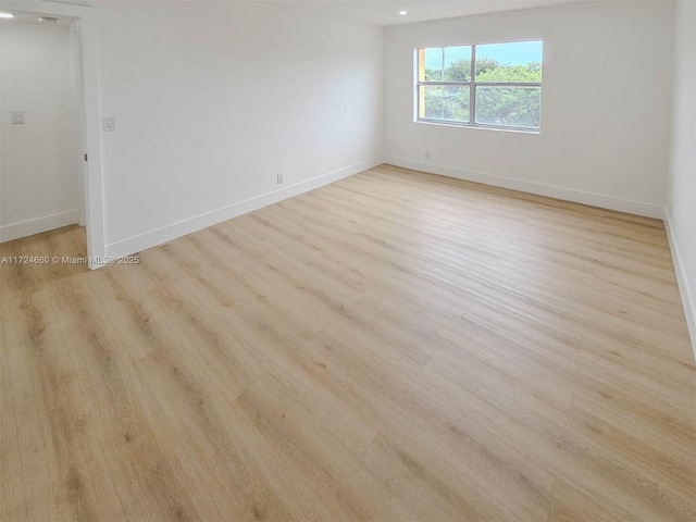 spare room with light hardwood / wood-style flooring