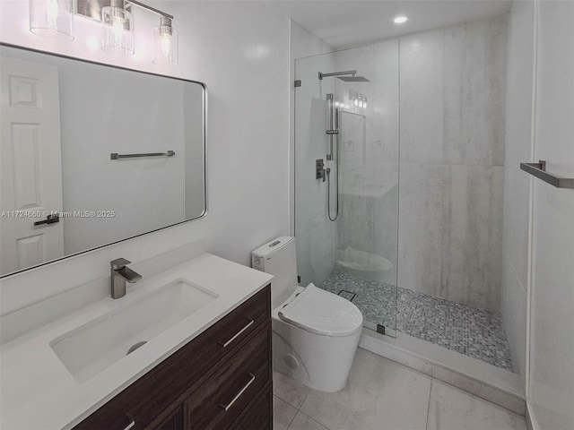 bathroom with tile patterned floors, toilet, vanity, and tiled shower