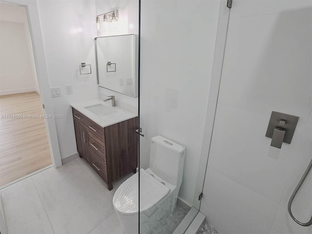 bathroom featuring vanity, toilet, and walk in shower