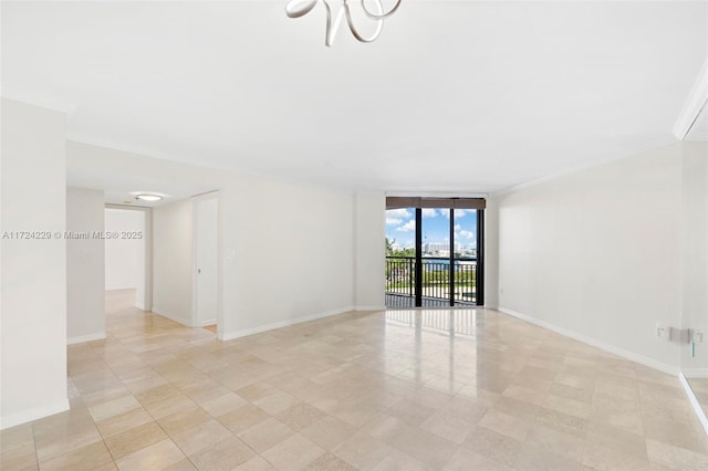 empty room featuring crown molding and floor to ceiling windows