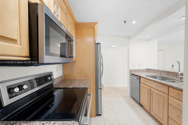 kitchen featuring sink, light brown cabinets, light stone countertops, and appliances with stainless steel finishes