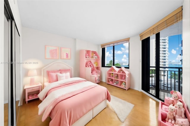 bedroom featuring hardwood / wood-style floors and access to outside