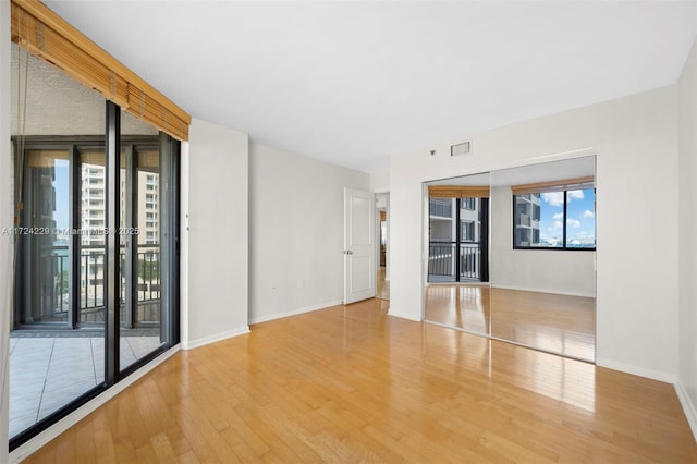 spare room with hardwood / wood-style flooring