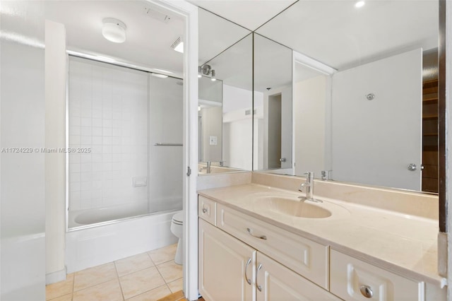 full bathroom featuring vanity, combined bath / shower with glass door, tile patterned floors, and toilet