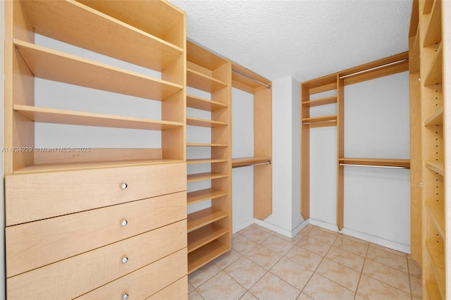 spacious closet featuring tile patterned flooring