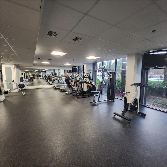 exercise room with a paneled ceiling