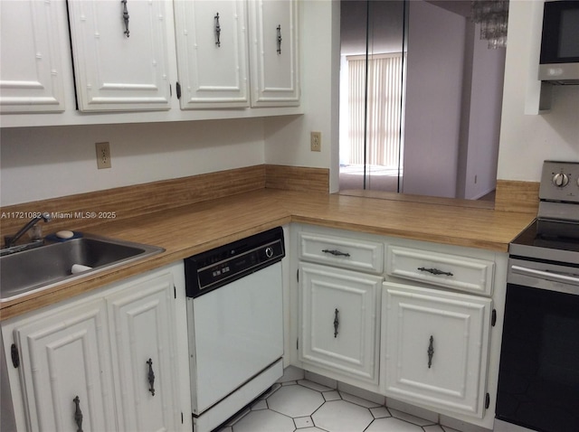 kitchen with sink, white cabinets, and appliances with stainless steel finishes