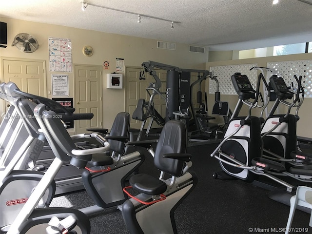 workout area featuring a textured ceiling