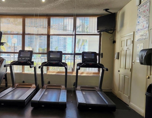 gym featuring a wealth of natural light and a textured ceiling