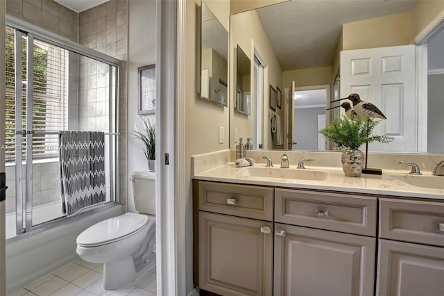 full bathroom featuring vanity, tile patterned floors, shower / bath combination with glass door, and toilet