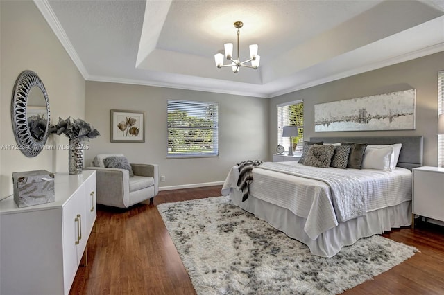 bedroom featuring an inviting chandelier, a tray ceiling, ornamental molding, and dark hardwood / wood-style floors