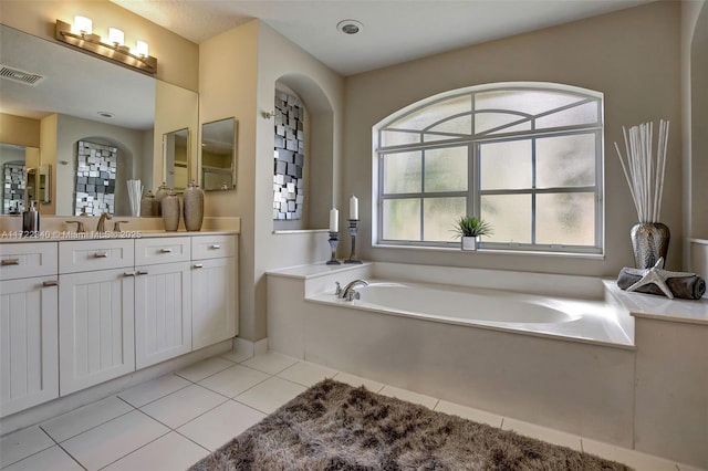 bathroom featuring tile patterned flooring, vanity, and a bathing tub