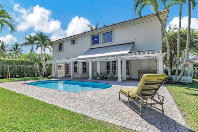 rear view of house with a fenced in pool, a patio, a yard, and a pergola