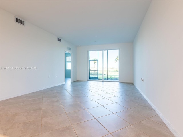 spare room featuring light tile patterned floors