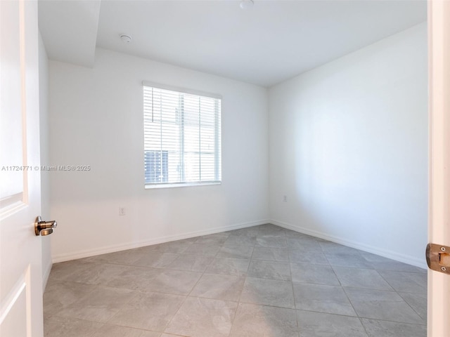 unfurnished room with light tile patterned floors