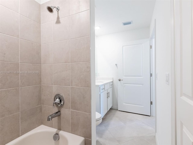 full bathroom with tile patterned flooring, vanity, toilet, and tiled shower / bath