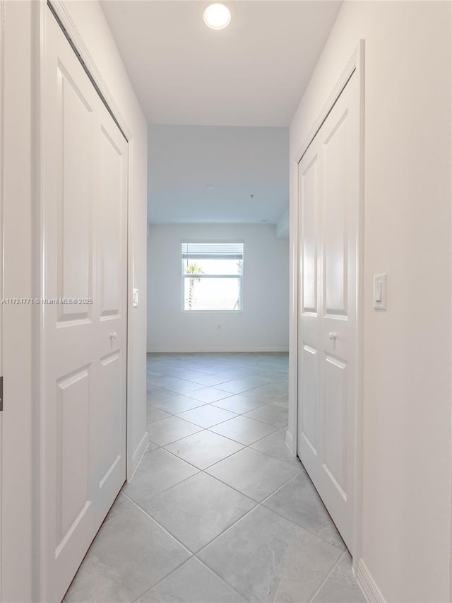 hall with light tile patterned flooring