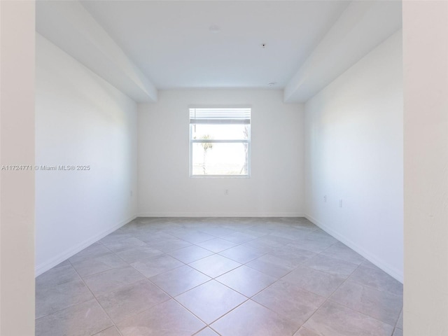 unfurnished room featuring light tile patterned floors