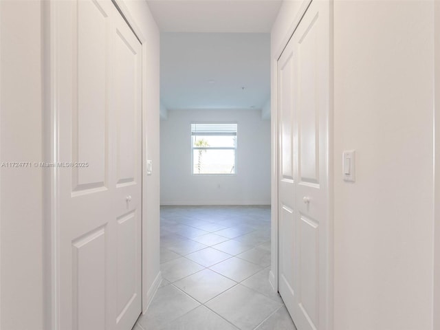 corridor with light tile patterned floors