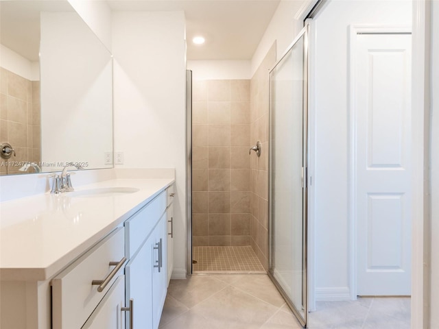 bathroom with tile patterned floors, vanity, and an enclosed shower