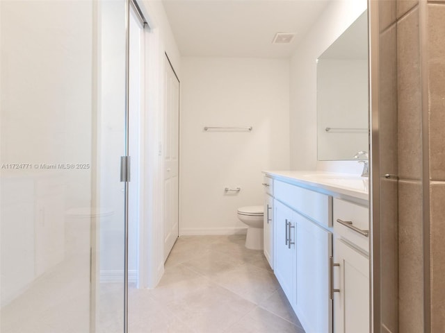 bathroom featuring tile patterned floors, vanity, and toilet