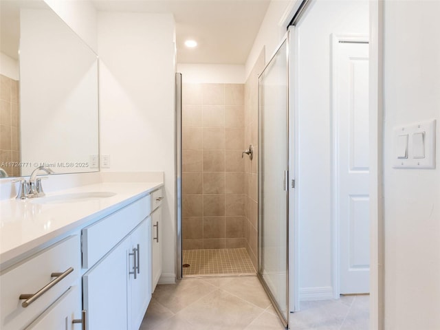 bathroom featuring tile patterned floors, a shower with door, and vanity