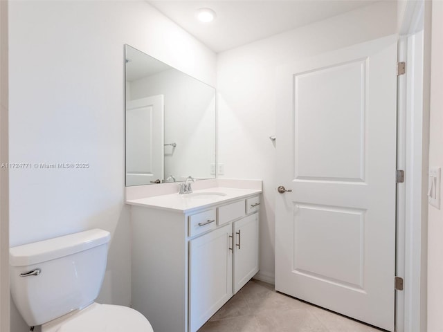 bathroom with tile patterned flooring, vanity, and toilet