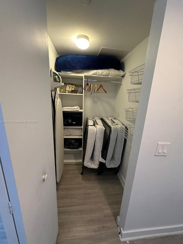 walk in closet featuring wood finished floors