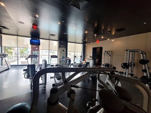 gym with visible vents and floor to ceiling windows